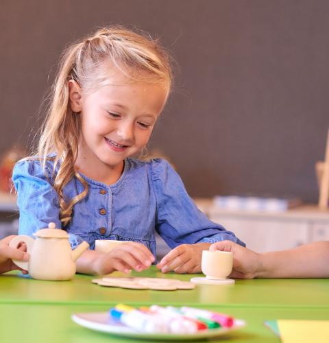 Group of young girls sitting at table.