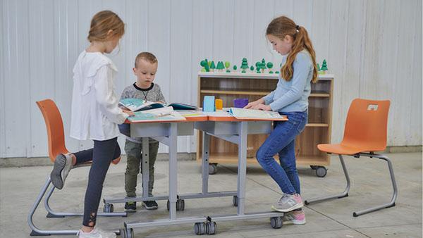 Young students working at group of tables with E! Seating.