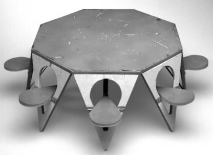 An octagon-shaped table with chairs attached to each edge.