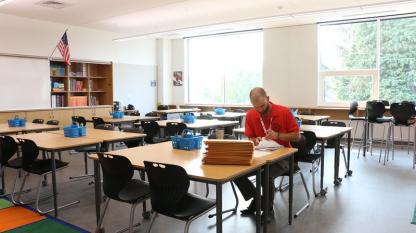 Classroom with tables and wall storage