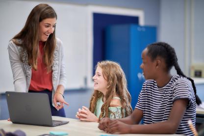 Teacher talking to two students