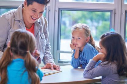Teacher talking with group of students.