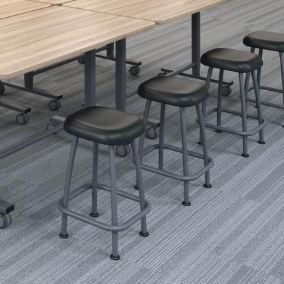 Row of black stools at table.