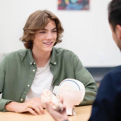Student talking with teacher.