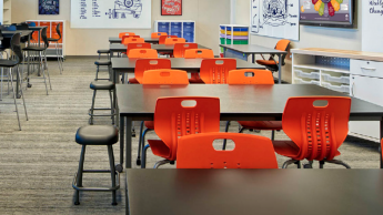 Classroom with brightly colored chairs and stools.